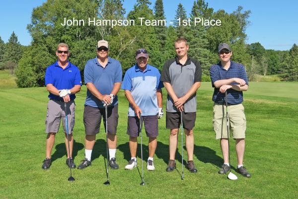 1st place team, John Hampson Team on golf course