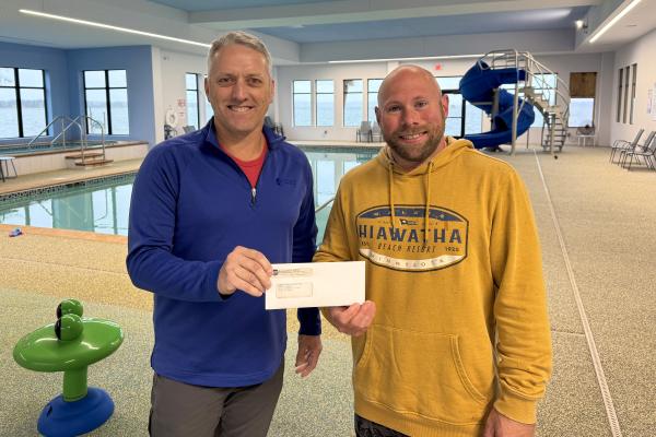 Bob Gregg presents a rebate check to A.J. Jacobson