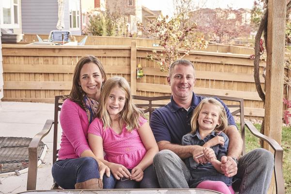 Family of four outside on patio