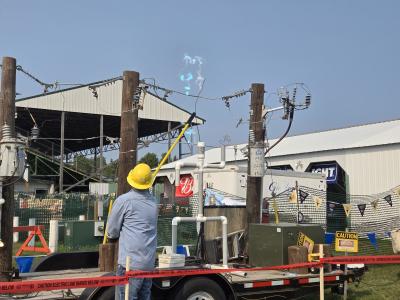 BEC Lineworker Trent Berglund draws an Arc during a high voltage electrical safety demonstration.